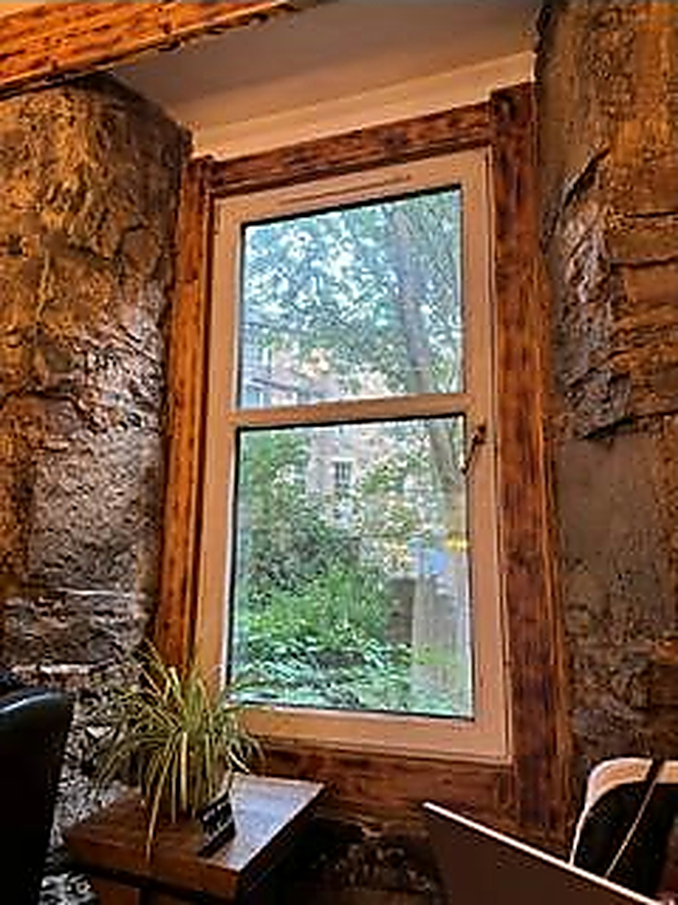 A quiet window nook framed by the café's old stone walls