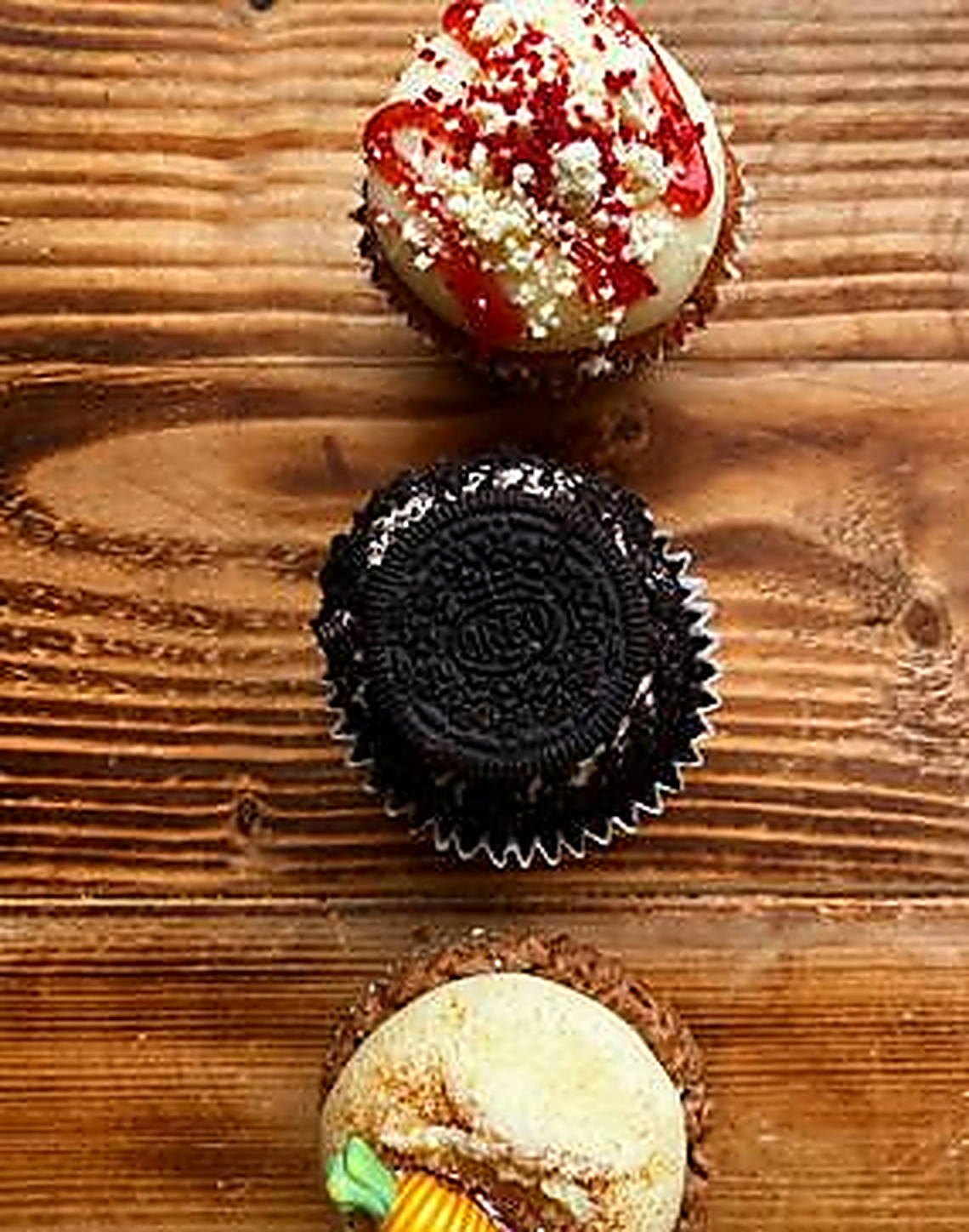 Three little cakes on a warm wooden table