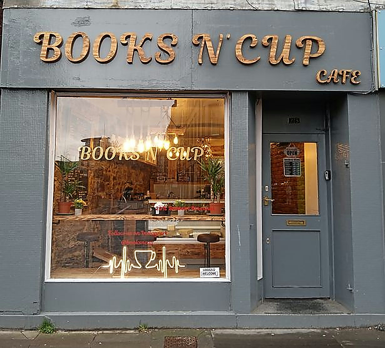 The Home St shopfront with gold Books N' Cup Cafe lettering