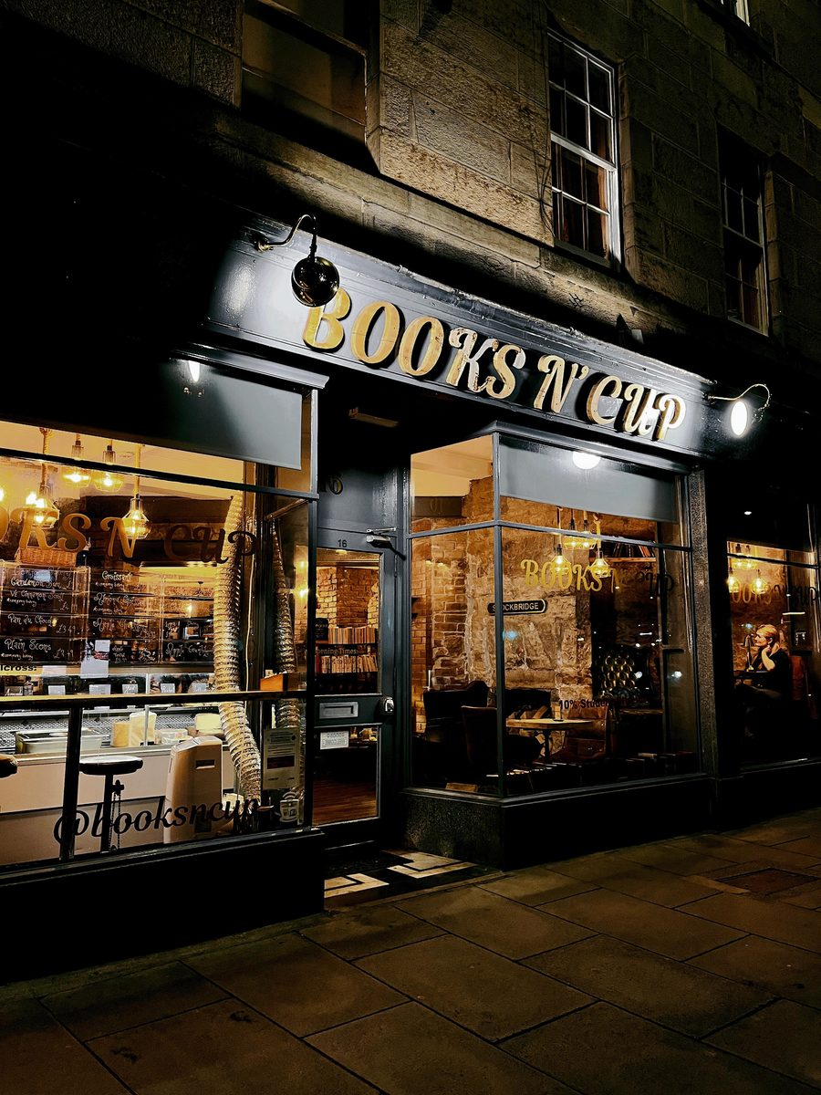 The shopfront after dark, windows glowing