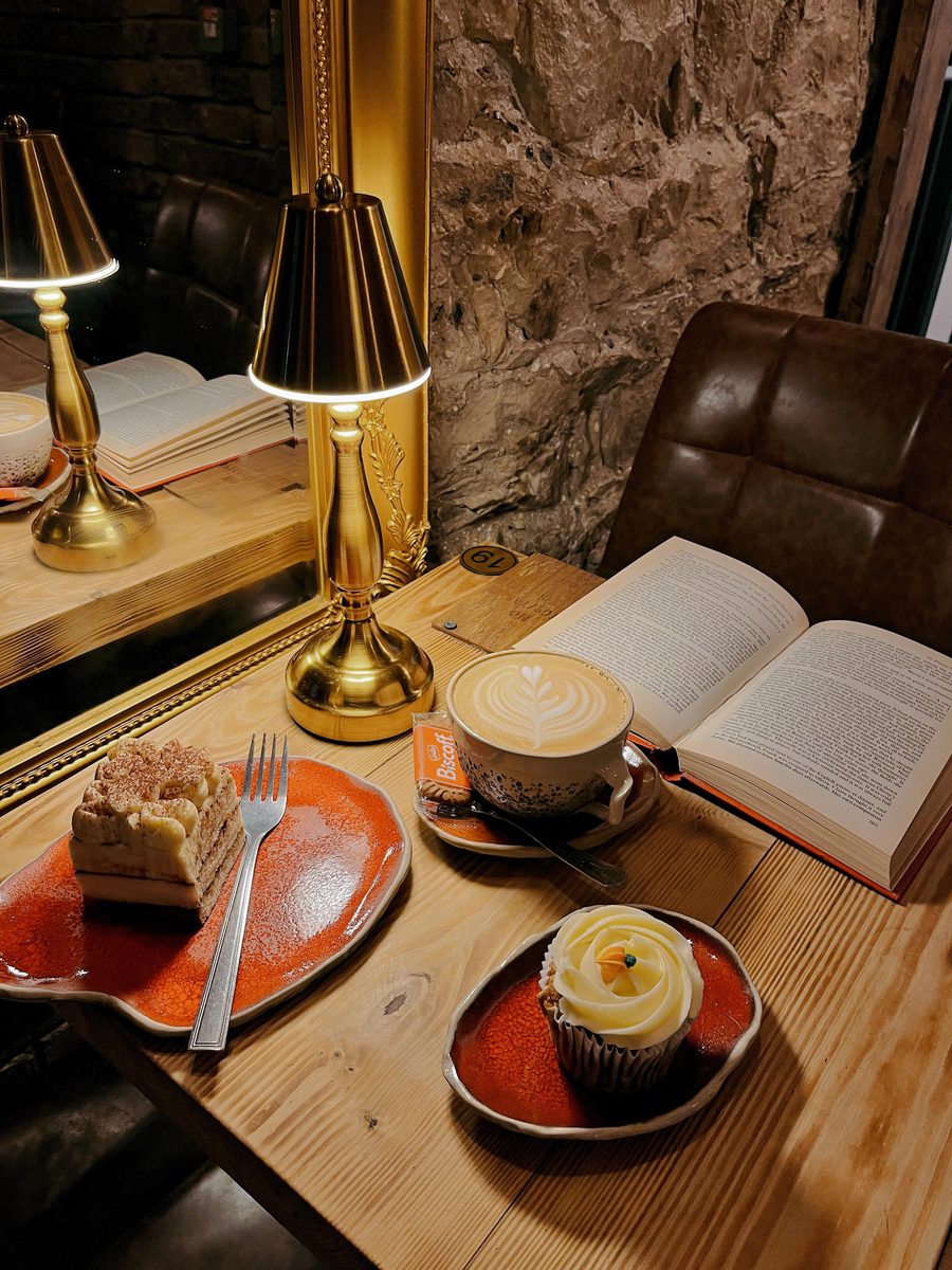 Cake, a book and a table lamp after dark