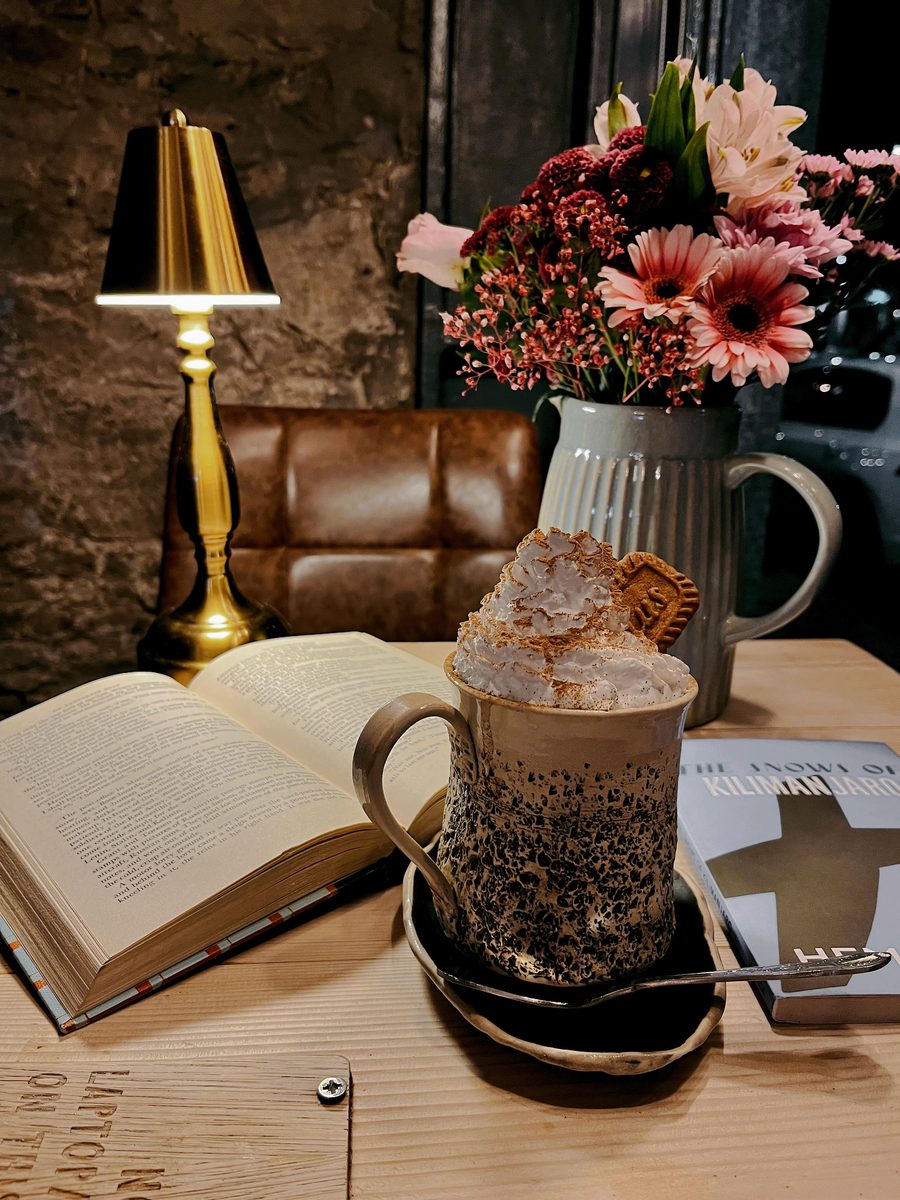 Hot chocolate, an open book and nowhere to be